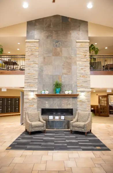 The Heritage at Legacy Lobby fireplace with chairs